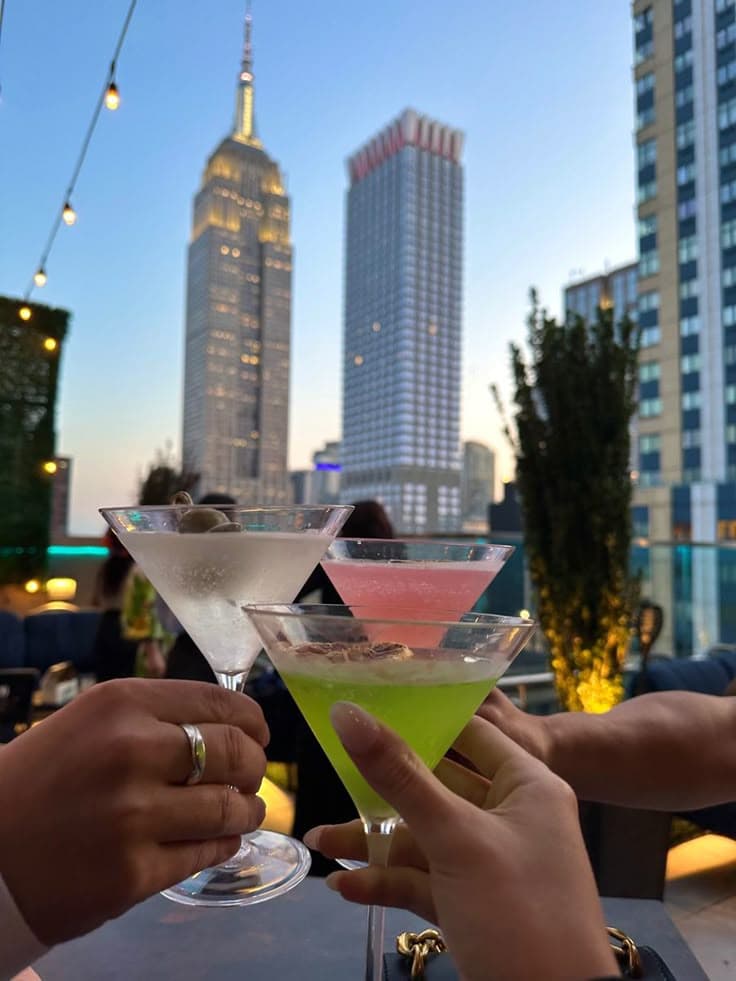 Friends having rooftop drinks at night